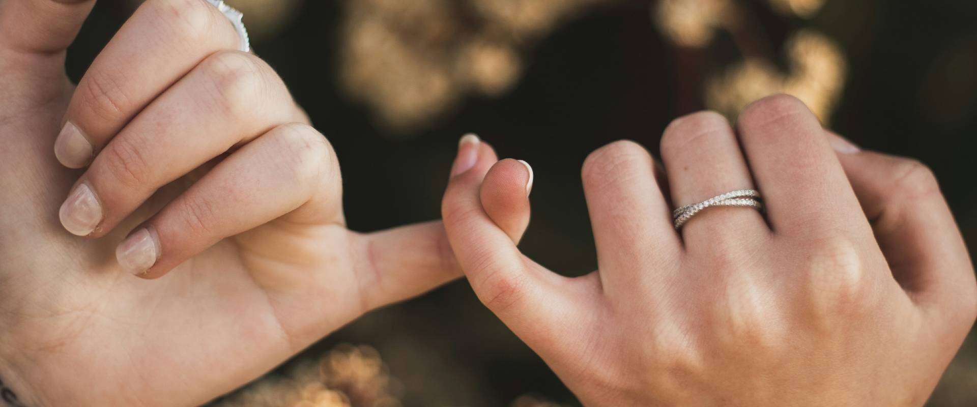 Two hands making a pinky promise, symbolizing trust in direct cremation vs funeral home care